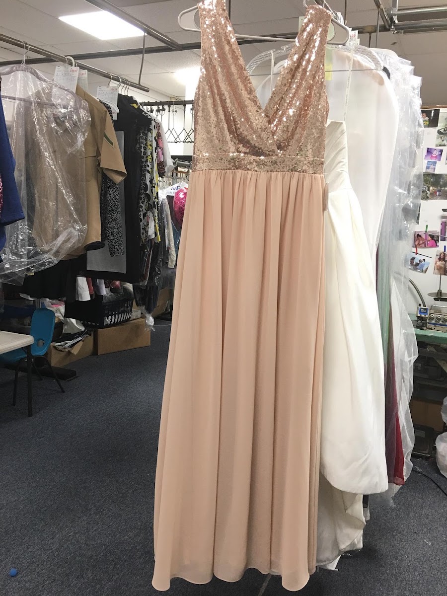 Blush sequin formal gown among gowns waiting for pickup