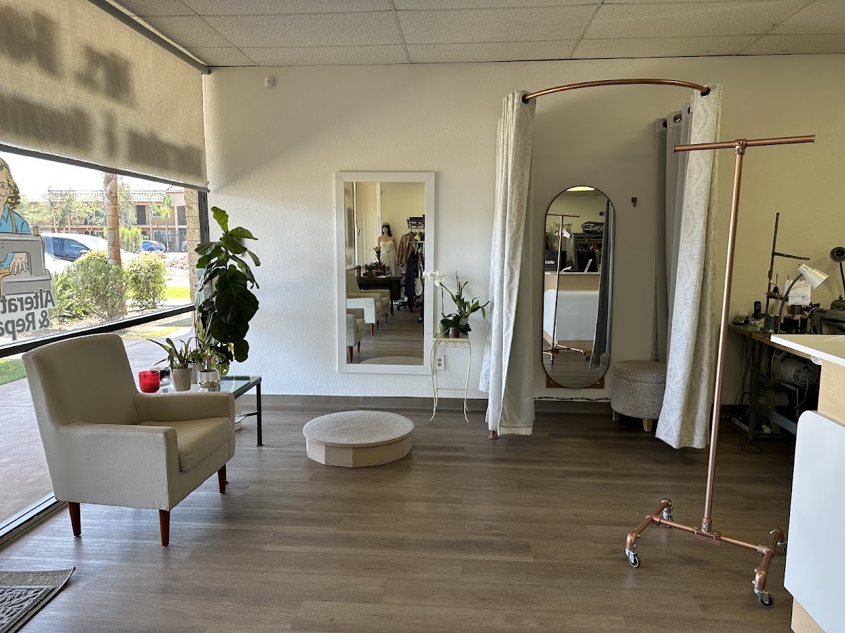 Bright fitting lounge with mirrors, seating and a fitting pedestal