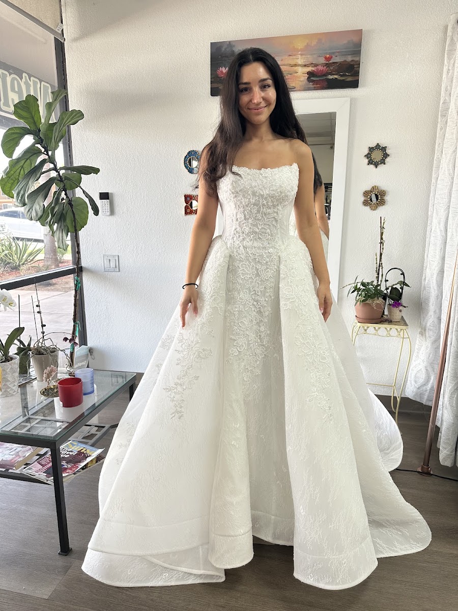 Strapless satin wedding gown with an overskirt